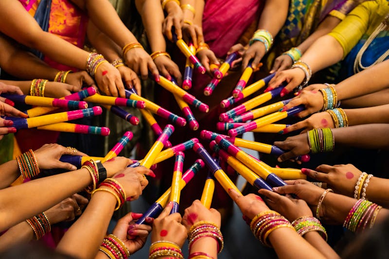 Women in colorful traditional attire performing Garba in a circle during Navratri celebration.