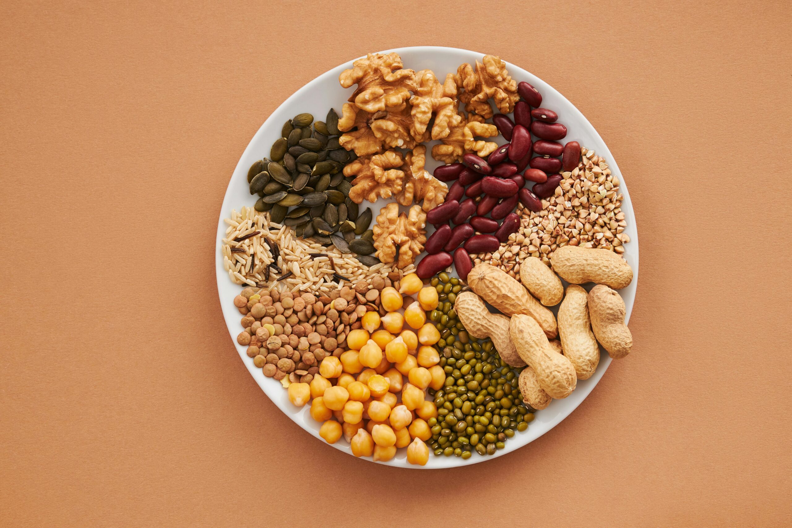 A colorful plate of superfoods including berries, nuts, seeds, and leafy greens