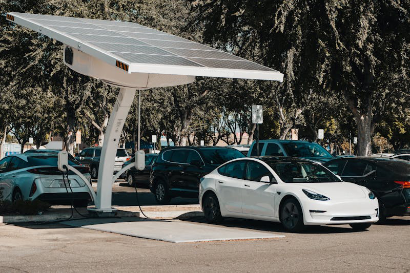 electric car charging at a station representing EV adoption and challenges